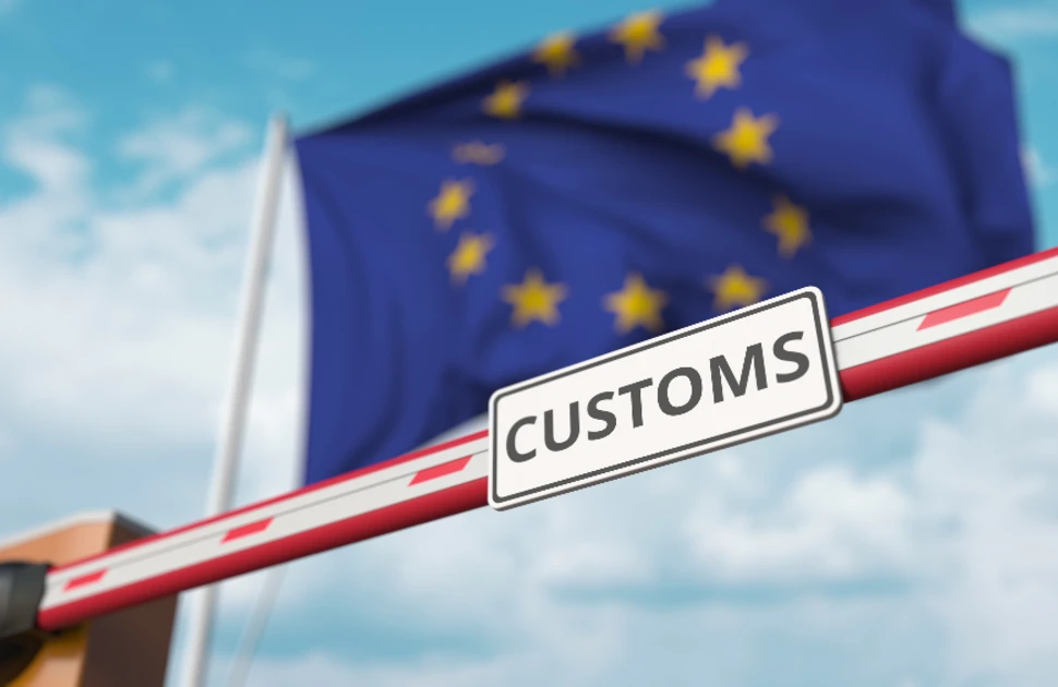 EU flag behind a customs border barrier