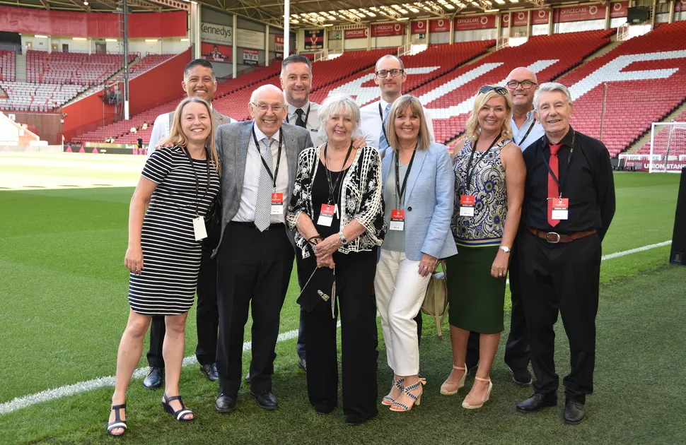 MEPS International senior members of staff standing on the pitch at Bramall Lane