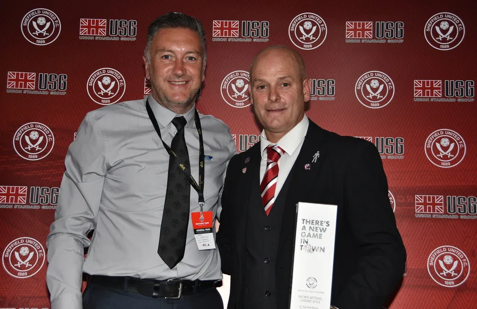 Jamie Milnes being presented an award by former Sheffield United player Carl Bradshaw