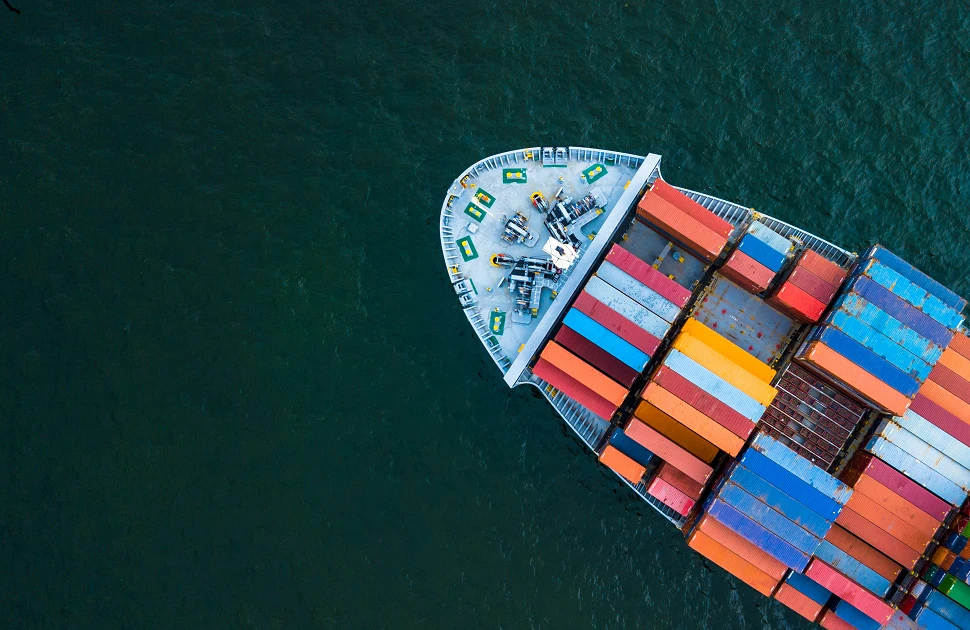 The front end of a fully-laden container ship on the sea