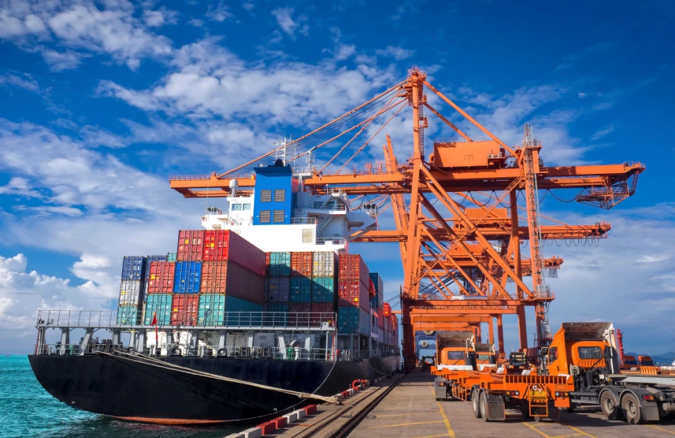 Cargo ship being unloaded at port