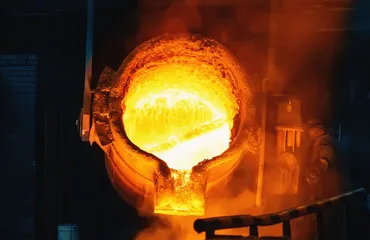 Large ladle with molten liquid metal in steel mill