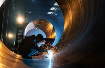 A pipemaker at work with a welding torch