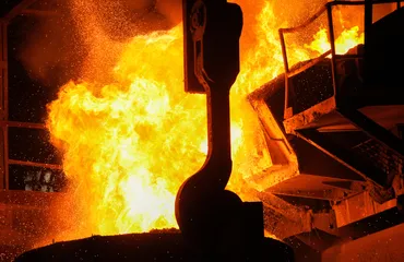 Steel production in electric furnaces. Sparks of molten steel. Electric arc furnace shop EAF.