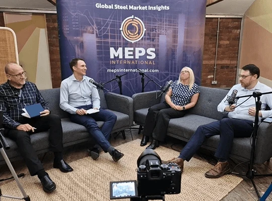 Four people discussing global steel market insights.