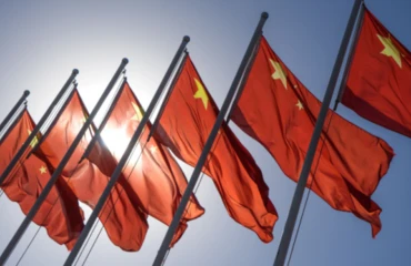 Chinese flags flying in sunlight