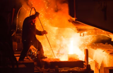 A steelworker oversees the operation of an EAF